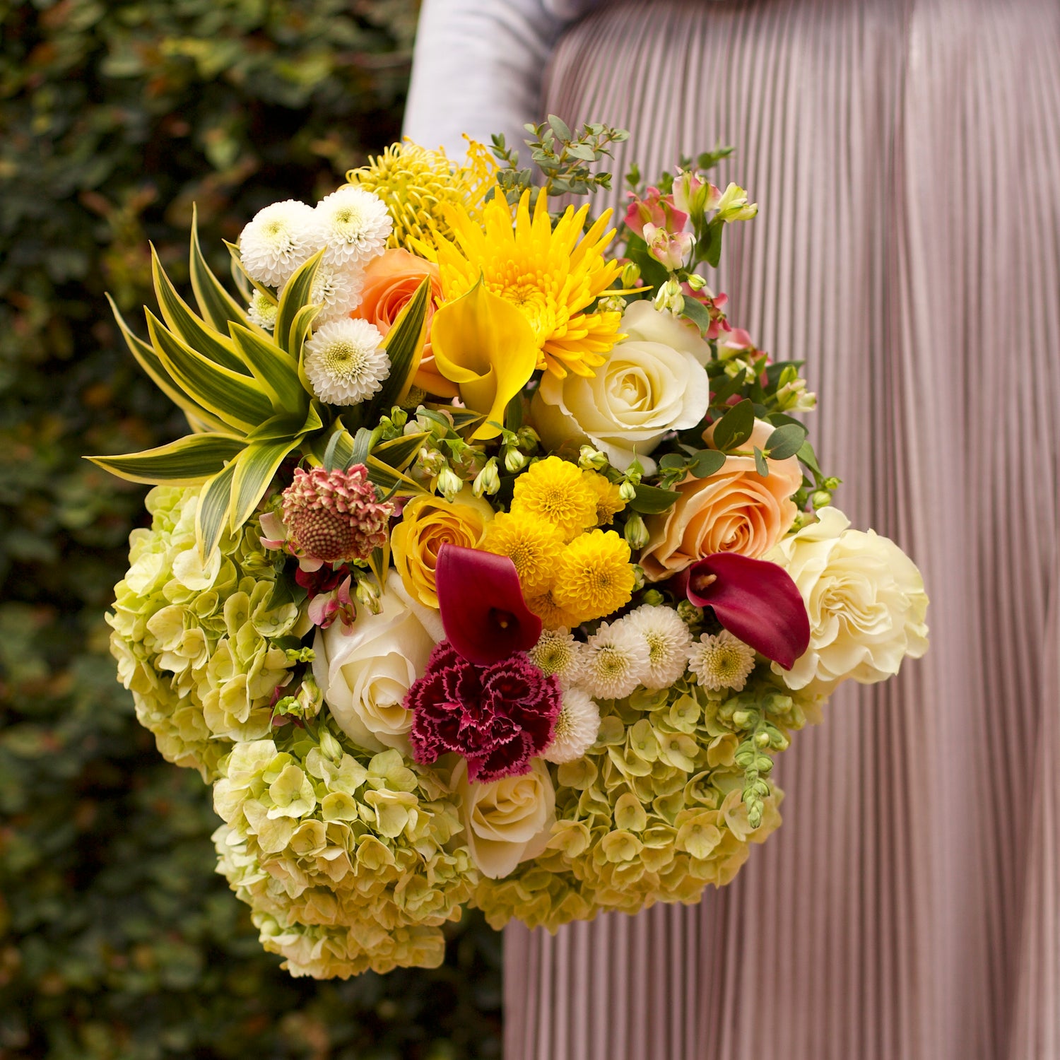 A Garden Collection bouquet features 30-35 stems of hydrangea, Callas, roses, and other farm-fresh varieties.