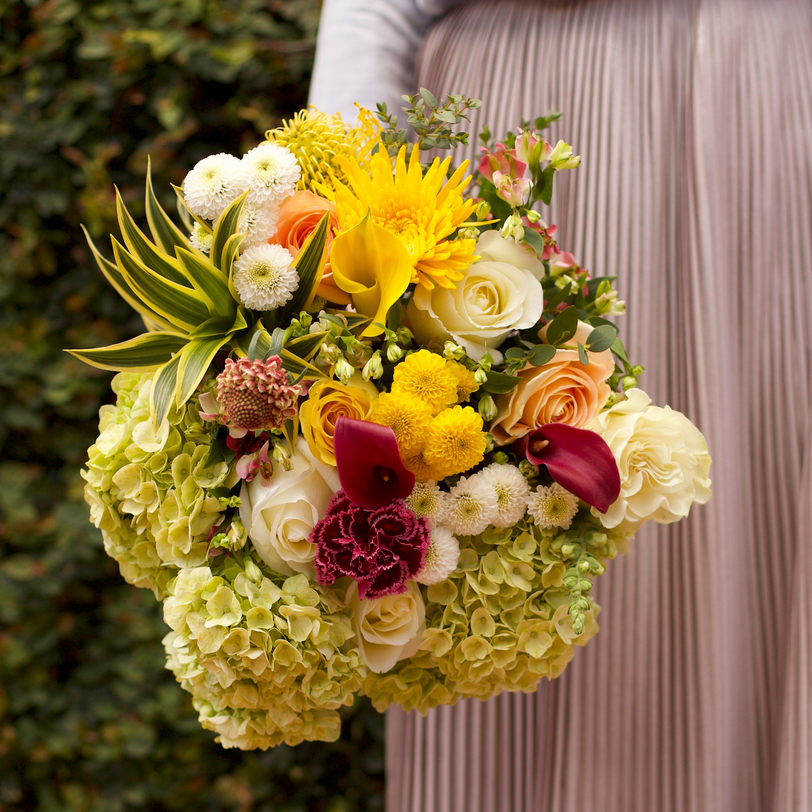 A Garden Collection bouquet features 30-35 stems of hydrangea, Callas, roses, and other farm-fresh varieties.