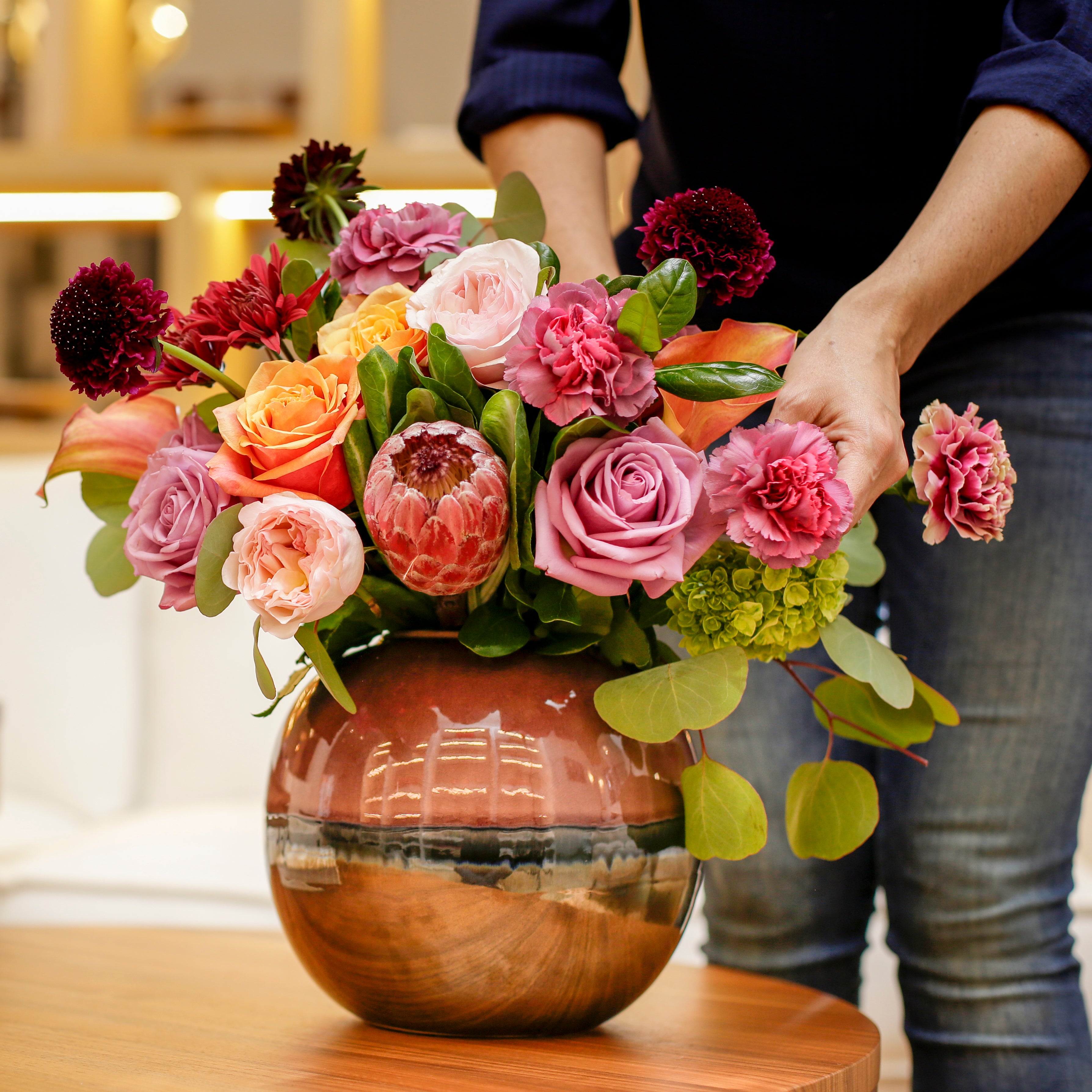 A Designer Collection bouquet features 30-35 stems of premium flowers including hydrangea, scabiosa, Garden roses, and more.