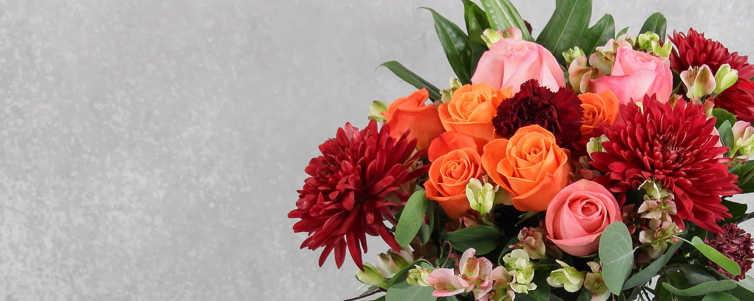 Big mixed beautiful bouquet of bright roses, carnations, pompons an other flowers