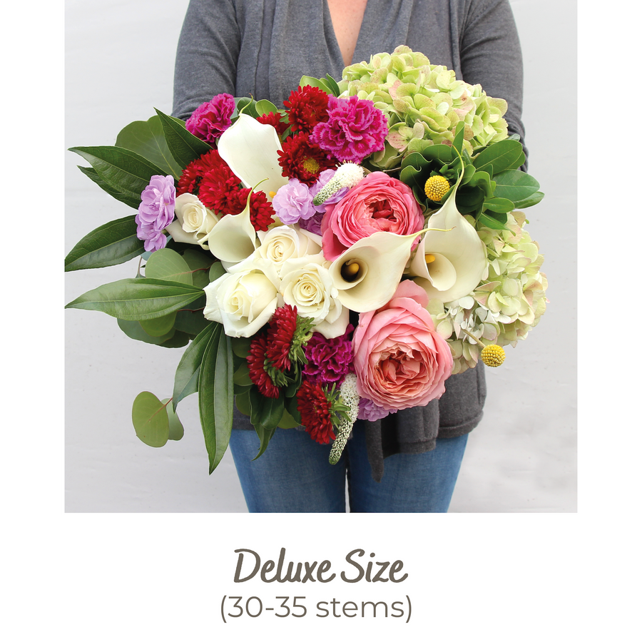 A Designer Collection bouquet features 30-35 stems of premium flowers including hydrangea, Callas, Craspedia, Veronica, Garden roses, and more.