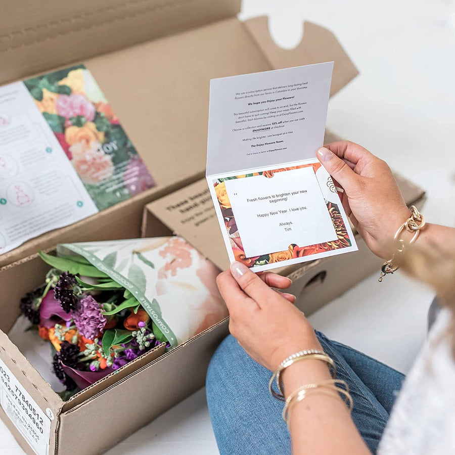 A Garden Collection delivery arrives in the Enjoy Flowers box, 30-35 stems of roses, Callas, and other farm-fresh varieties, and a personalized card.