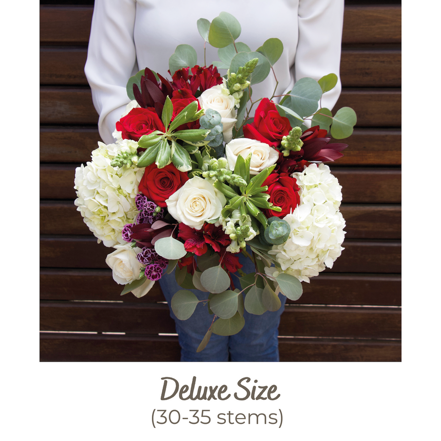 A Garden Collection deluxe bouquet features 30-35 stems of red and cream roses, snapdragons, and other farm-fresh varieties. 